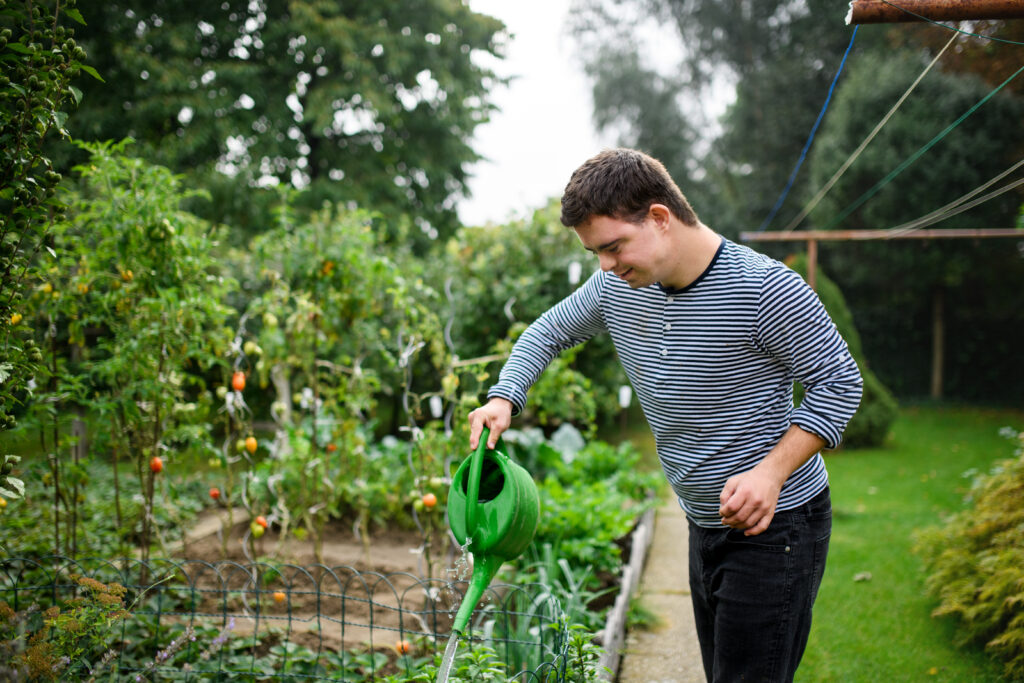 IDD person watering green garden
