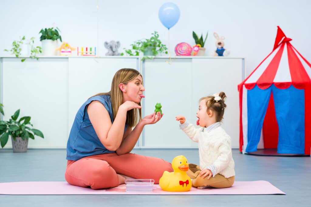 developmental interventionist working with a toddler on the floor