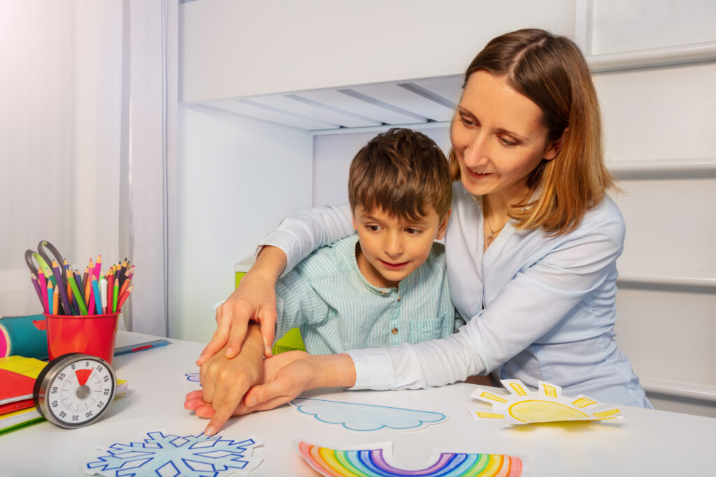 kid with learning disability in in a behavior health service with drawings