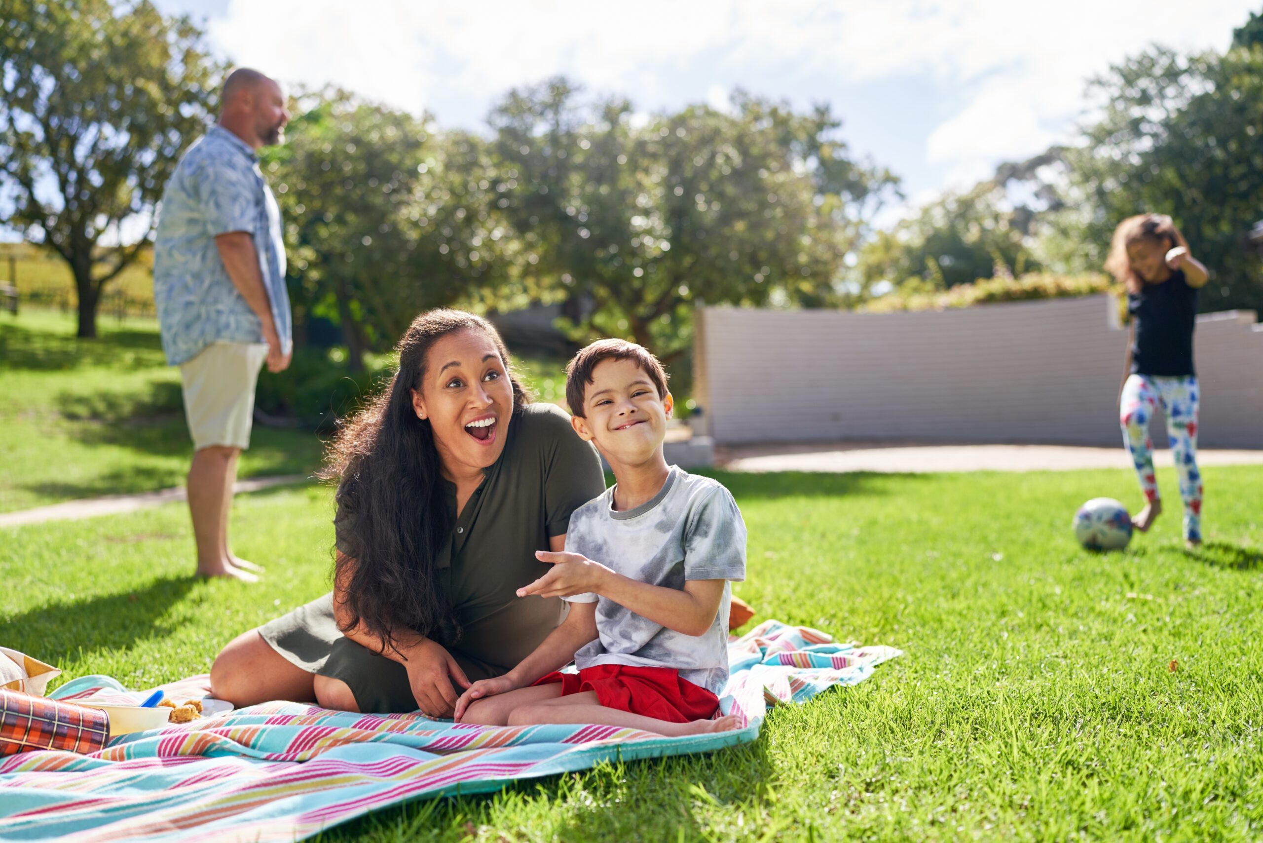 IDD individuals on a picnic blanket enjoying summer