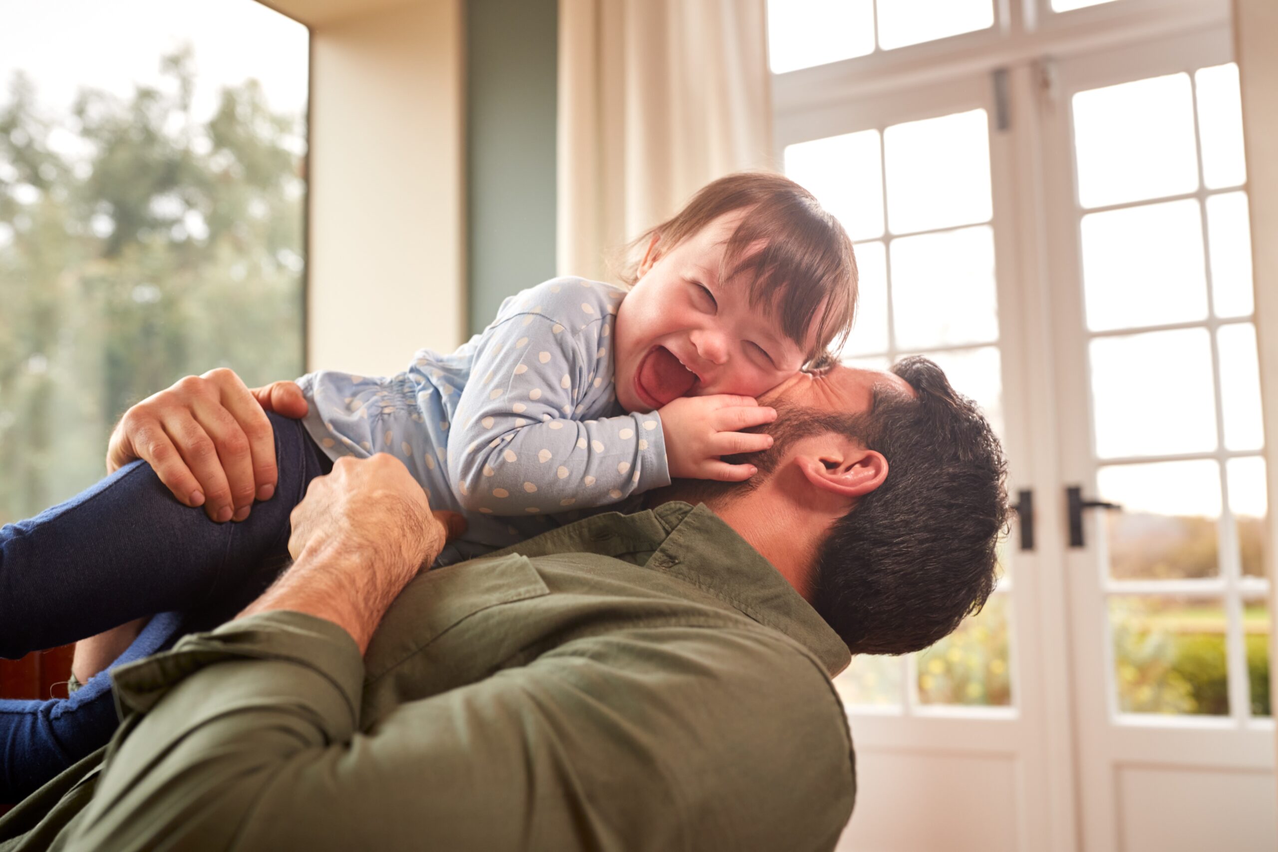 child with developmental disabilities with loving dad who seeked out early intervention service coordinator
