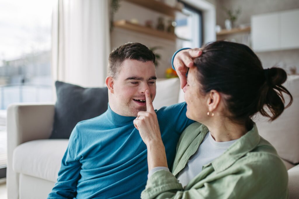 disabled child with mom booping noses