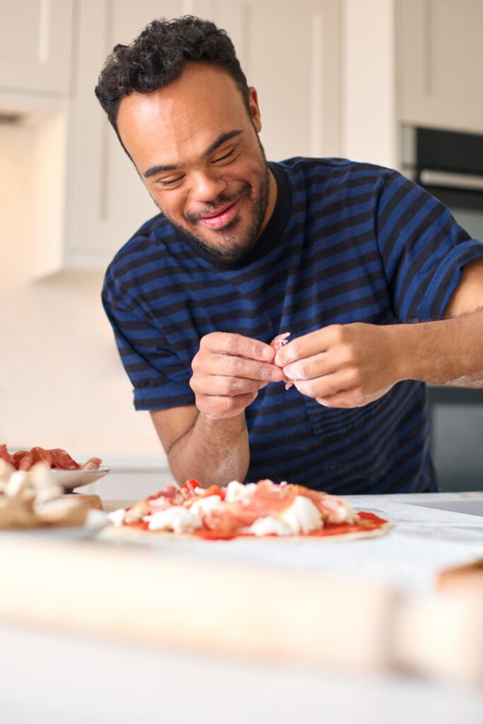 IDD man happy making pizza in cooking class 