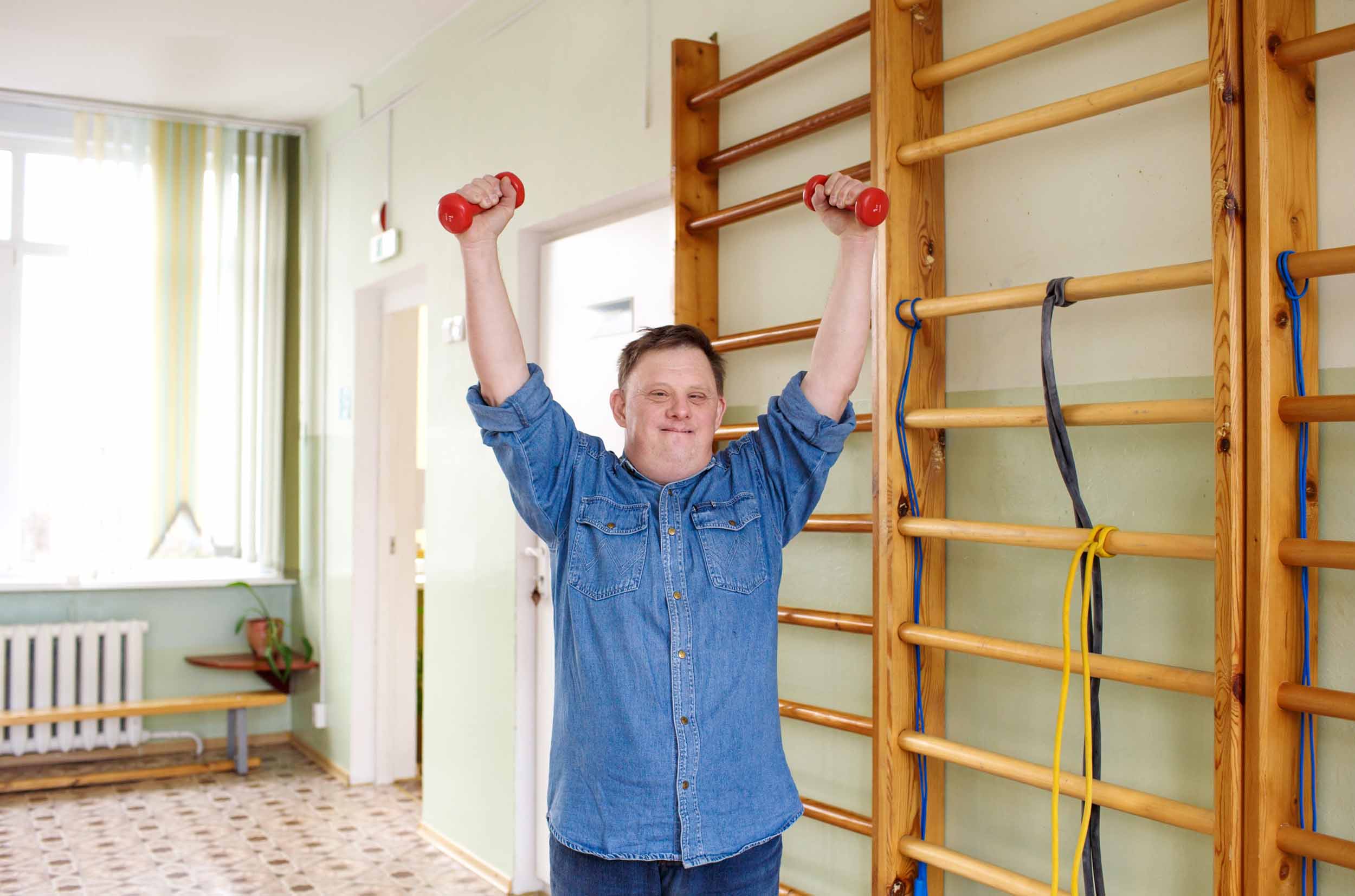 A man with Down syndrome lifts weights